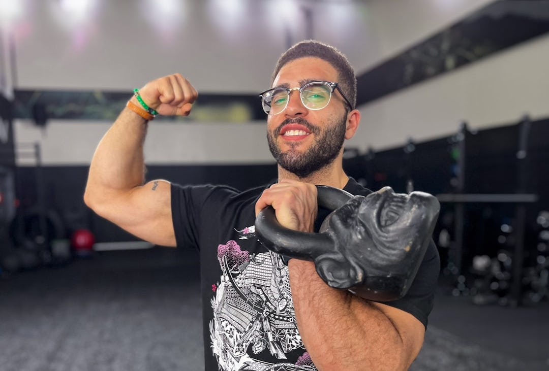 Coach Jarrod Cardona poses with an Onnit Primal Bell.